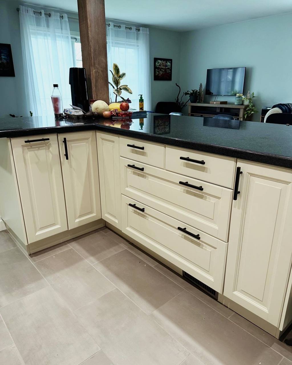 After photo of the same kitchen with newly painted off-white (Mist Air by Benjamin Moore) cabinets and pantry doors, featuring new gold hardware and a brighter, more open feel ~ George town, Toronto.