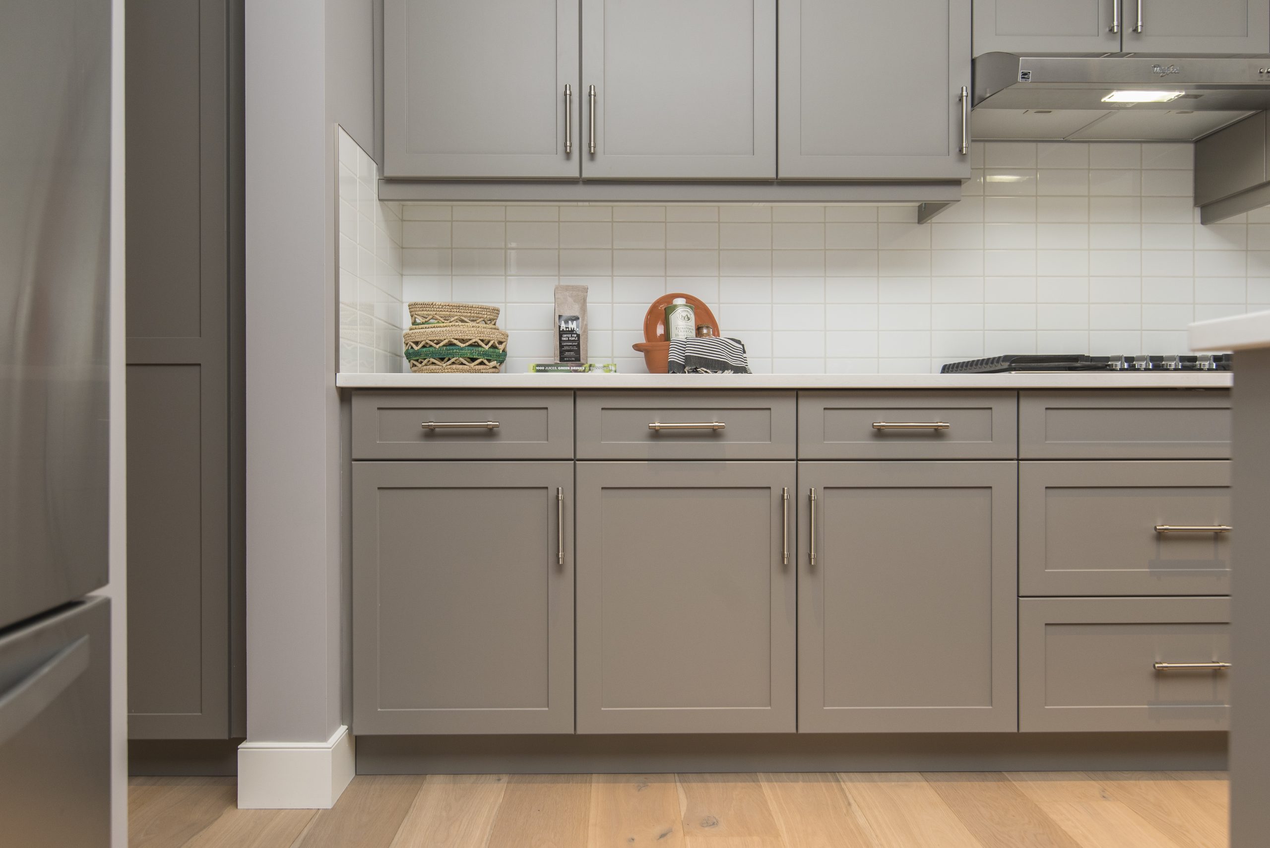 Modern kitchen with professionally refinished grey cabinets, new hardware, and a bright countertop in a home in Richmond Hill, Toronto.