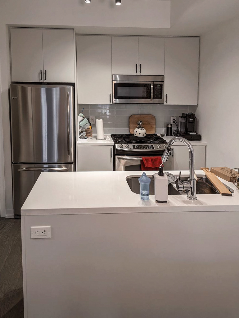 Kitchen cabinets professionally painted by the best cabinet painter to a durable, Grey Owl with a flawless factory-like finish.