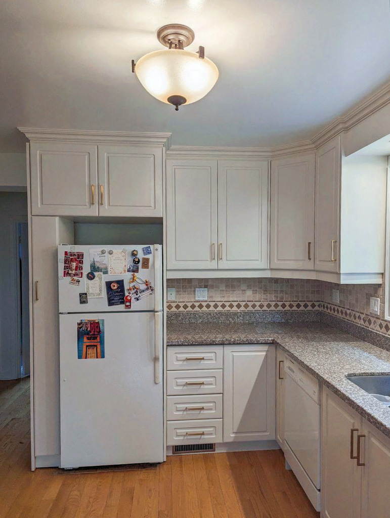 Kitchen cabinets professionally refinished by the best cabinet painter to a durable, warm creamy white with a flawless factory-like finish.