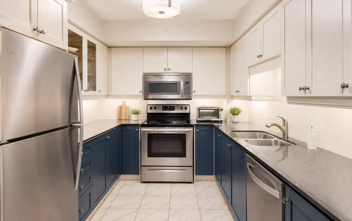 Fresh white and navy kitchen cabinet painting Toronto condo