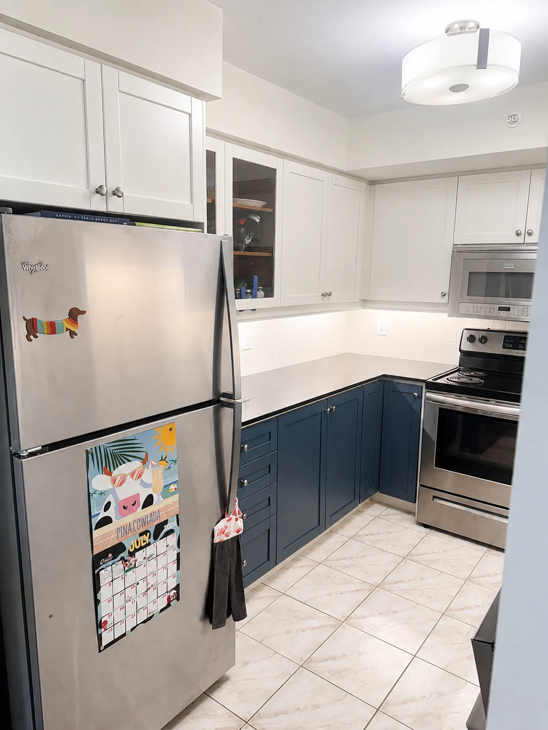 Fresh white and navy kitchen cabinet painting Toronto condo
