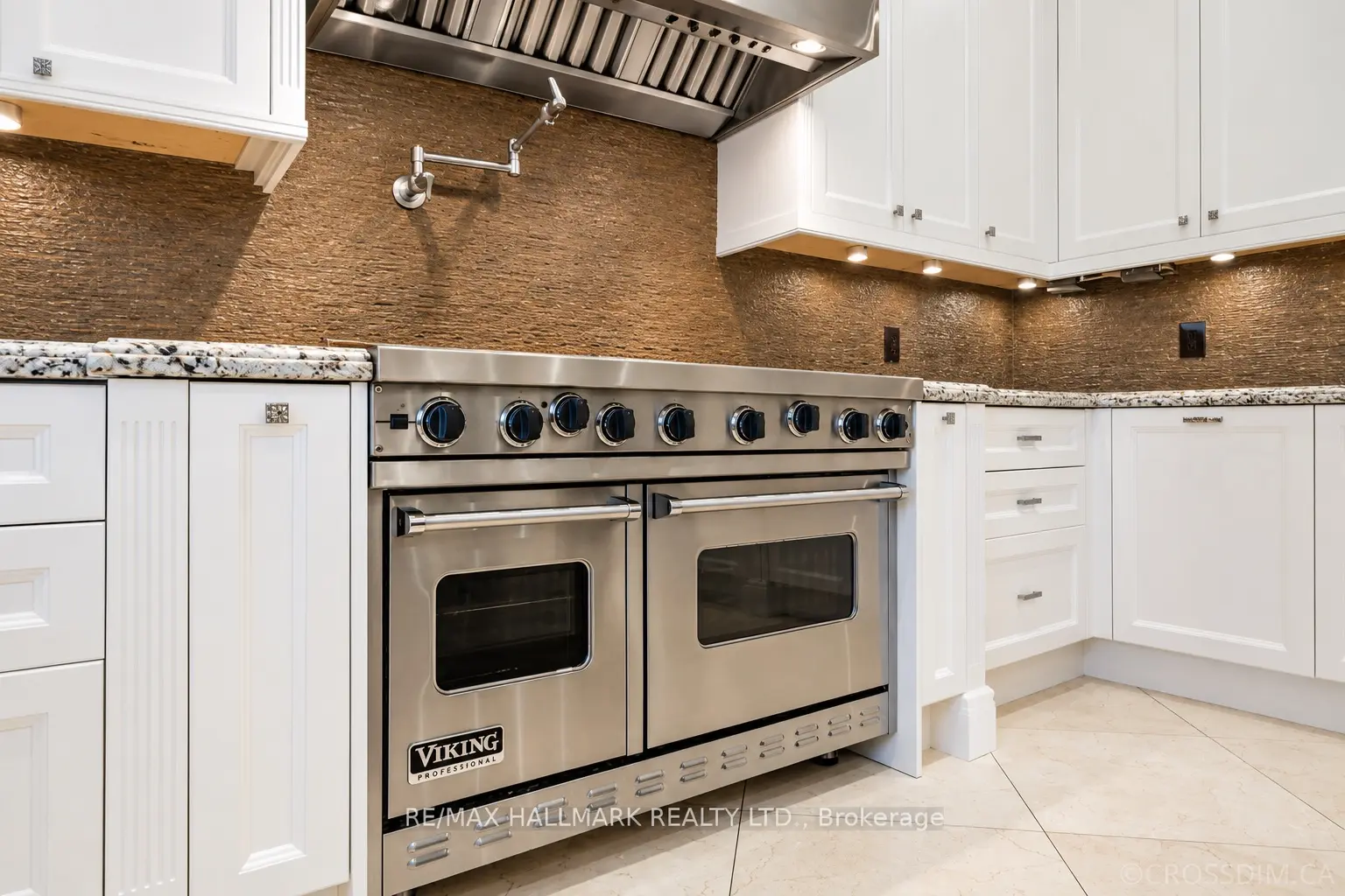 White Dove kitchen cabinets after professional painting in Richmond Hill, with a stainless steel range and textured backsplash.
