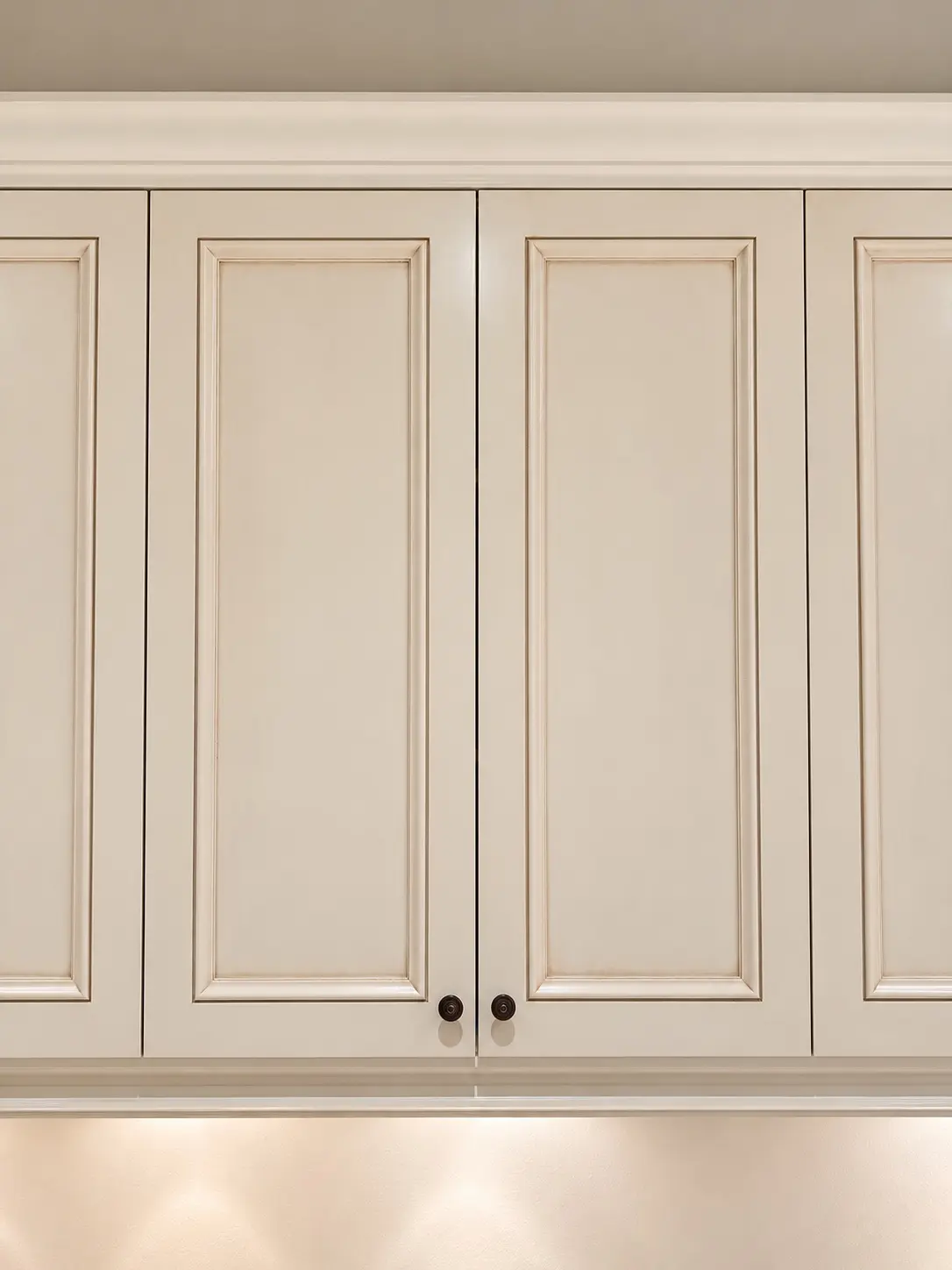 Close-up of a laundry cabinet door after repainting in warm beige