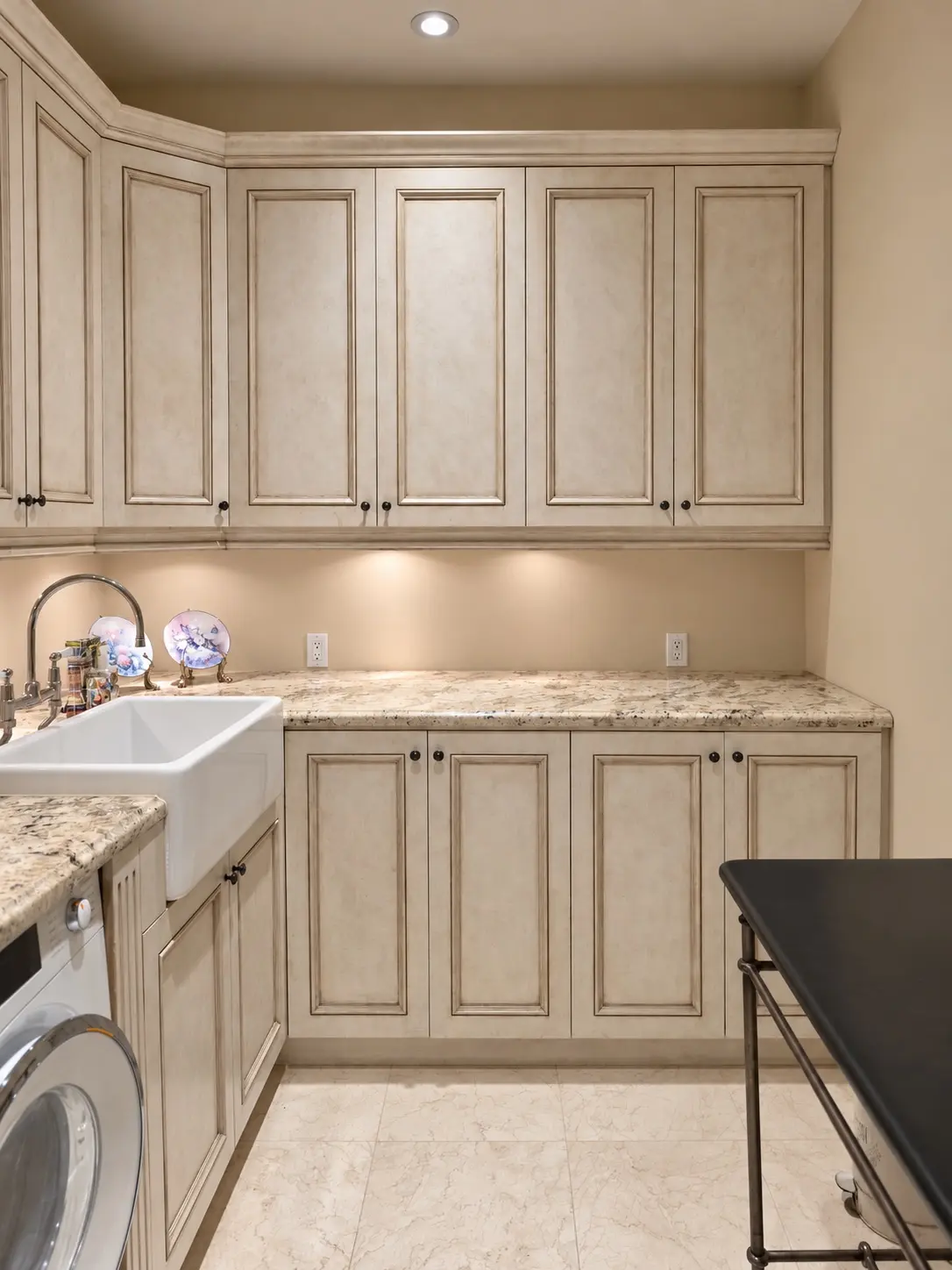 Laundry room cabinets with their original antique-glazed finish before repainting