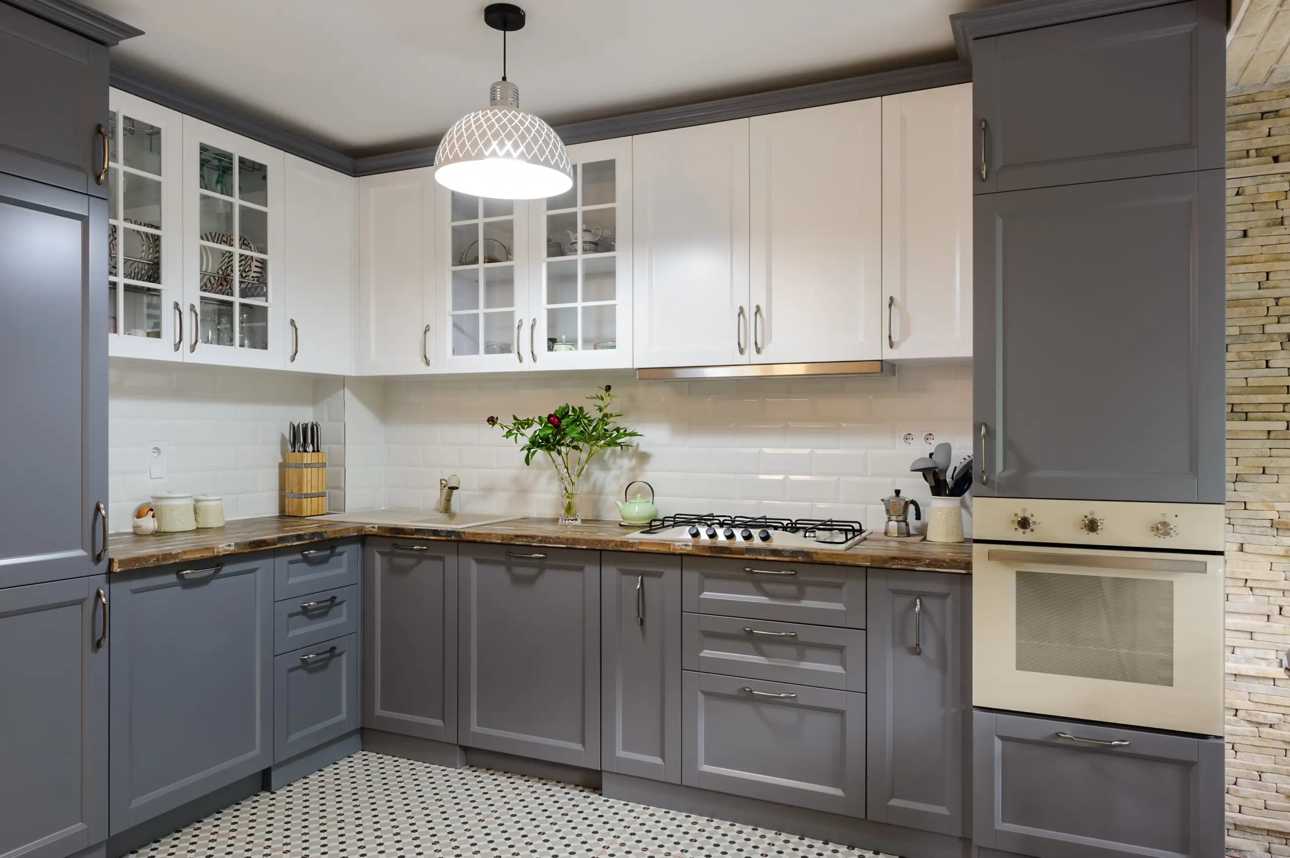 Two-tone kitchen with white upper cabinets and grey lower cabinets